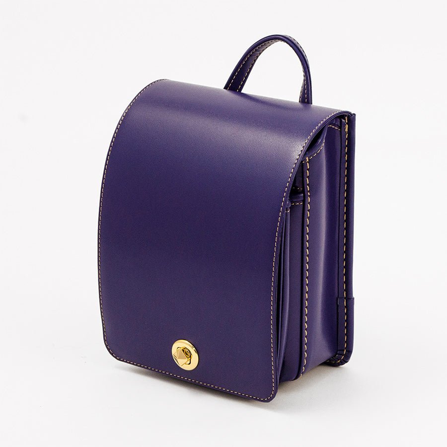 Purple leather backpack with a gold clasp on a white background