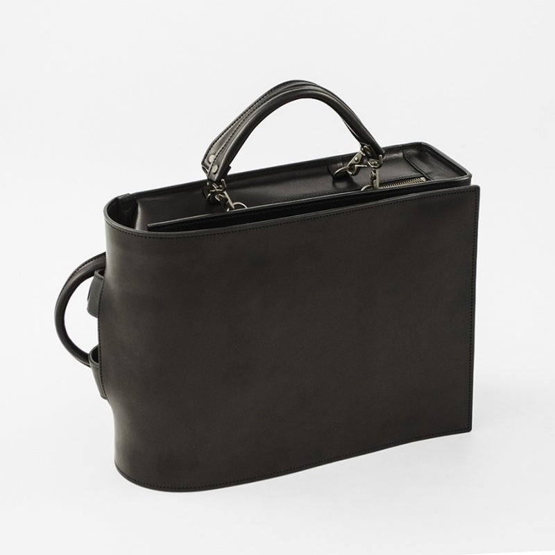 Black handbag with a shoulder strap on a white background